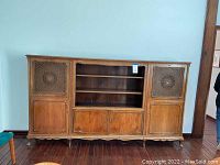 Full view of the German beechwood cupboard showing cane detail on door panels, with three lower solid wood cabinet doors and central open shelving