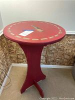 Full side view of the red wine pedestal table showing the base and height.