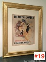 Full view of the framed poster print showing gold frame and matting.