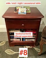 Front view of contemporary one drawer end table showing polished wood finish, single drawer, and open shelf. Books shown are offered separately and not included.