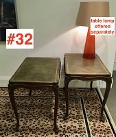 Pair of end tables front view on leopard print rug, lamp on one table