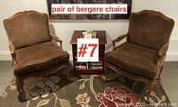 Pair of bergère chairs in natural wood frame with brown textured upholstery, shown side by side