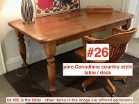 Front angle view of pine harvest style table with natural finish, showing table top and turned legs.