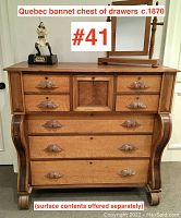 Full front view showing overall form, finish, original hardware and five drawers