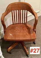 Front angle view of the maple swivel office chair showing the contoured seat, slatted backrest, and armrests.