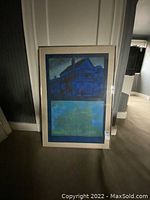 Full view of framed print leaning against wall, showing two-panel design and silver frame