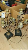 Pair of vintage brass and stone candelabra with tarnish and multiple candle holders