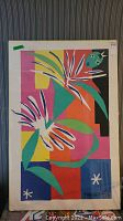 Front view of abstract floral print with foam board edges and plastic wrap