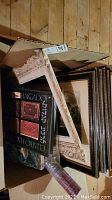 Box containing framed prints and boxed set of Judaica books