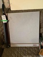 Top-down view of the Dahl cutting board showing the grid surface and cutting blade on one side.