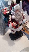 Full view of the 31 inch Santa Claus figurine showing the entire figure including the gift sack, costume, and base.