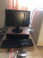 HP desktop computer tower with Windows XP license stickers, Gateway 17-inch monitor on top, Dell keyboard and cables in foreground.