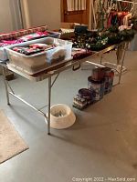 Overhead front view of folding table loaded with various items.