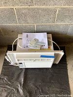 Top view of GE window air conditioner with side panels extended, displaying unit condition and shape.