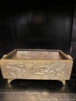Front and side view showing detailed dragon and cloud motif carvings on the bronze jardiniere.