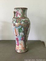 Front view of porcelain vase showing famille rose figures and floral motifs