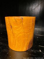 Front view of the old Asian hardwood brush pot showing natural wood grain, cracks, and surface wear.