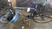 Full side view of blue Sport Rock Specialized M2000 bicycle showing flat tires and frame branding