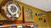 Photo of Seiko round wall clock, Capricorn burlap art, and three metal cars on wood wall
