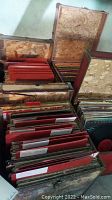 Four OSB wood boxes filled with vinyl records and red separators