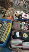 Overall view of five crates/boxes of assorted vinyl records (45s and LPs).