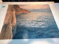 Photo of full seascape print showing cliffs, ocean, and sky in detailed colors.