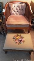 Front view of the tufted velvet cane side chair and footstool with floral needlepoint cover