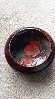 Photo of small round ceramic bowl showing interior floral design