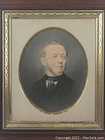 Full view of the Victorian portrait encased in a gold gilt wooden frame, showing the oval-shaped vintage color photograph within the decorative frame.