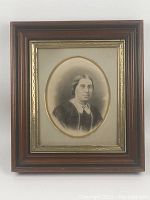 Full view of the antique wooden frame with gold gilt inner frame and mat, displaying sepia photographic portrait of Victorian woman.
