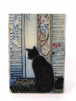 Front view of resin print artwork depicting a black cat sitting facing a window with patterned shutters, signed by artist Rochelle.