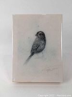 Full view of the resin print over wood featuring the bird illustration with artist signature.