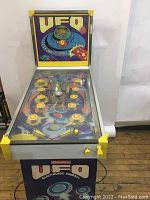 Front and side view of assembled pinball machine standing upright