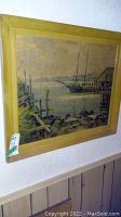 Full view of the framed vintage harbor scene painting with a dock and sailboat under muted sky.