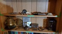 Overall view of two shelves showing all items in lot