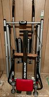 Front view of Action Row rowing machine with red seat pad and foot rests