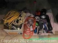 Overview of all cords, extension cords, flashlights and electrical accessories in one box.