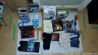 Full view of personal grooming items including packaged and loose items on white surface.