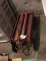 Overhead view of the vintage wagon showing wooden slatted bed and metal wheels and handle