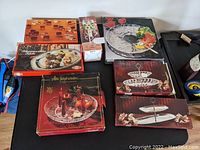 Overview of all vintage serving pieces in their original boxes arranged together on a surface, showing various sizes and designs.