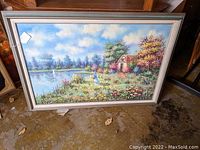 Full view of the framed oil painting on canvas showing the cottage, pond, flowers, woman, and sky.