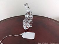 Clear crystal paperweight shaped as a chef wearing a hat, standing and holding a mixing bowl, original red and gold Orrefors label on front.