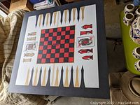 Top-down view of vintage game table showing formica top with printed chess and backgammon boards and chess piece designs.
