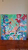 Full view of the original acrylic painting with bold colorful abstract botanical shapes on canvas.