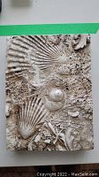 Front view of Sid Dickens art tile with seashell and marine fossil relief