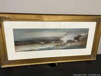 Frontal view of the pastel painting showing the stormy ocean scene with crashing waves and rocky coast in a gold ornate frame with white matte.