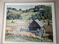Full view of framed landscape painting showing rural scene of fields, barns and wooded hills