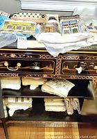 Eight ceramic wall plaques displayed on shelf with decorative furniture