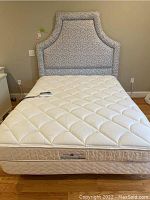 Queen bed assembled showing headboard, mattress and base
