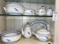 Full view of the set displayed on glass shelves, showing all items together.